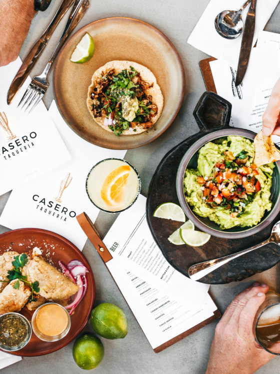 A spread of Mexican food, drinks and menus from Casero Taqueria.